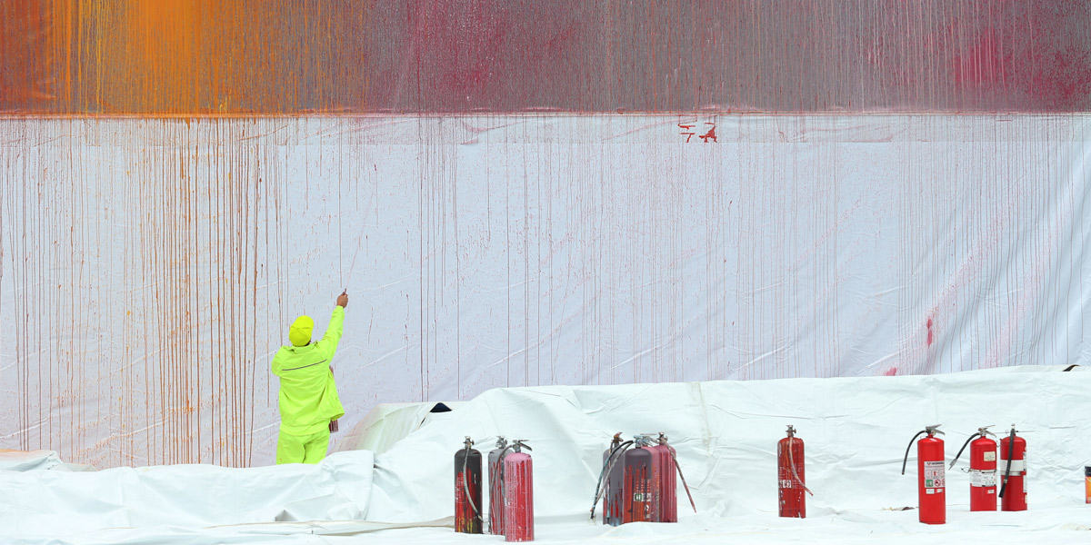 Ash Keating paints a 19m x 7.5m art instillation on the side of the NGV. Photo: AAP