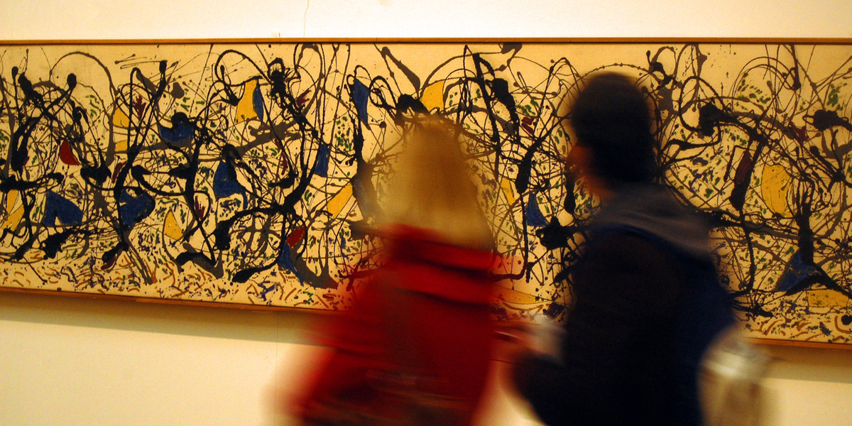 Gallery visitors examine a work by abstract artist Jackson Pollock in London's Tate Modern.