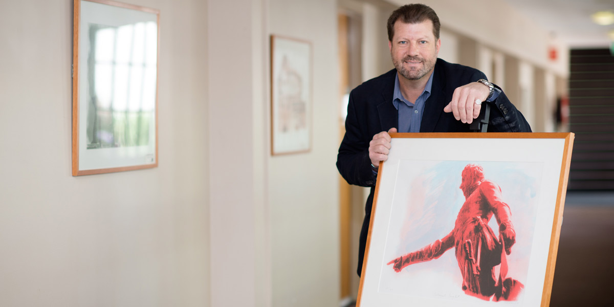 Jonathon Rice with a Colonel Light lithograph. Photo: Nat Rogers/InDaily