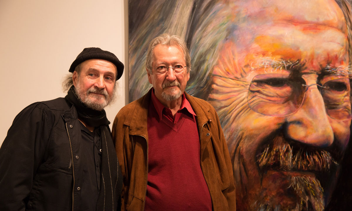 Artist Bruno Jean Grasswill and actor Michael Caton next to Grasswill's 2015 Archibald People's Choice award-winning portrait. Photo: AAP
