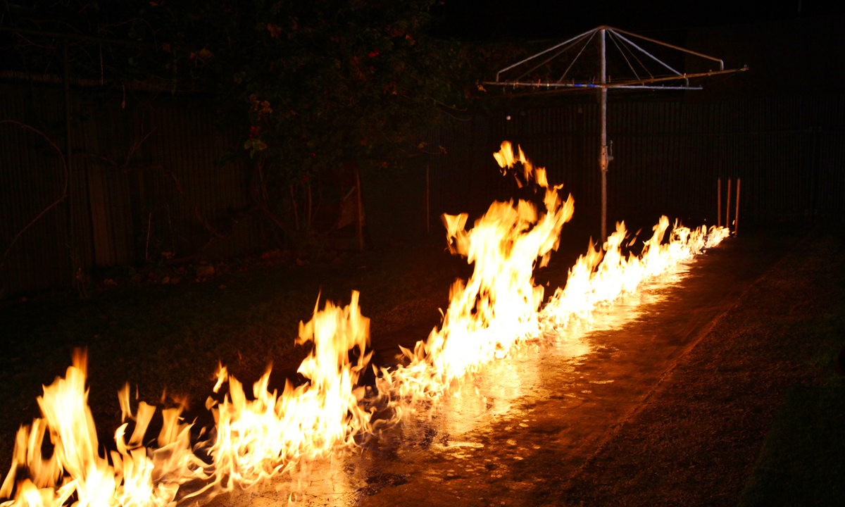 Backyard Pitch: a still from The Summation of Force, by Trent Parke and Narelle Autio