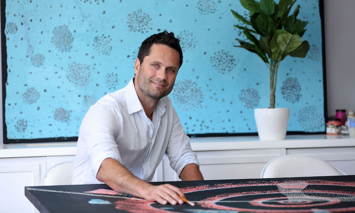 Gavin Wanganeen with his paintings. Photo: Mark Piovesan