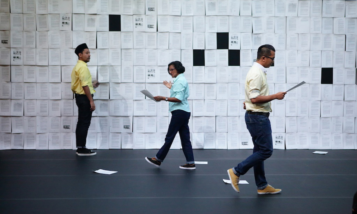 Baling: The actors read from pages of transcript which they tear from the wall.