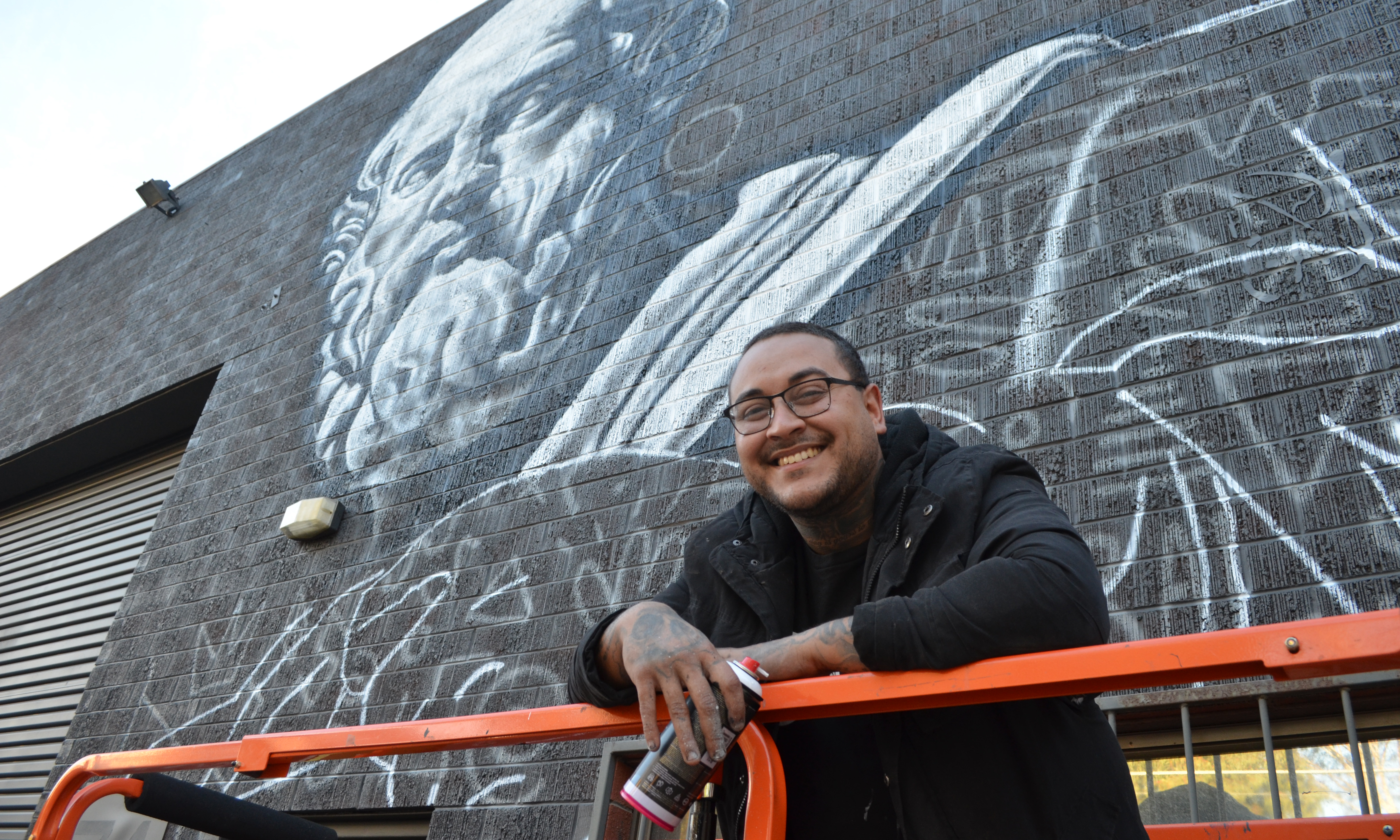 Thomas Readett on the first day of his Praxis mural project. Photo: Angela Skujins