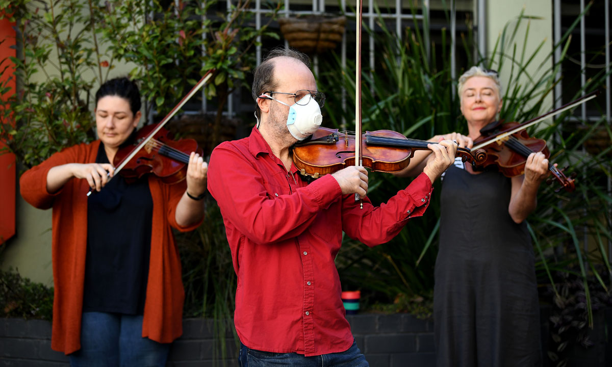Members of the Opera Australia Orchestra perform outside OA's offices last Thursday to call on the company to reconsider its decision to stand down musicians without pay. Photo: AAP