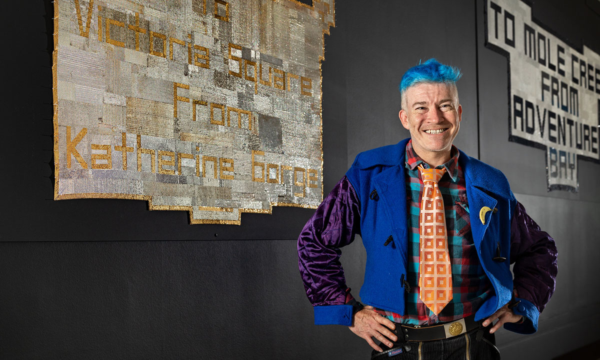 Troy-Anthony Baylis with works in his Postcard series at the AGSA. Photo: Saul Steed 
