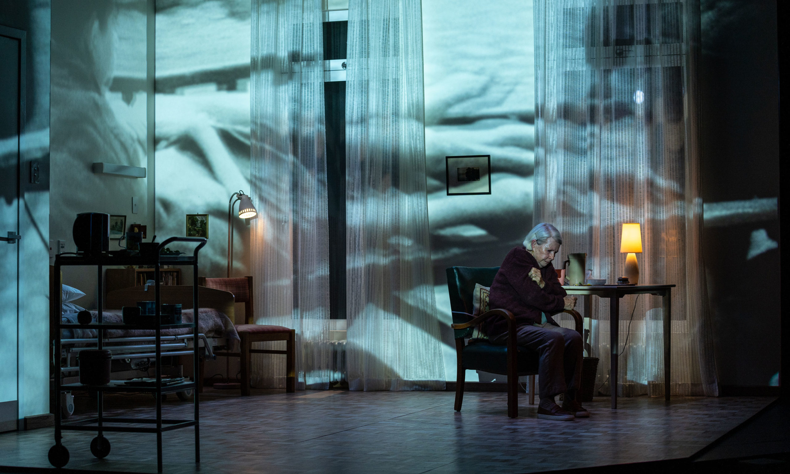 A German Life: The bare walls of an aged-care room serve as screens for archival footage that punctuates the narrative. Photo: Andrew Beveridge