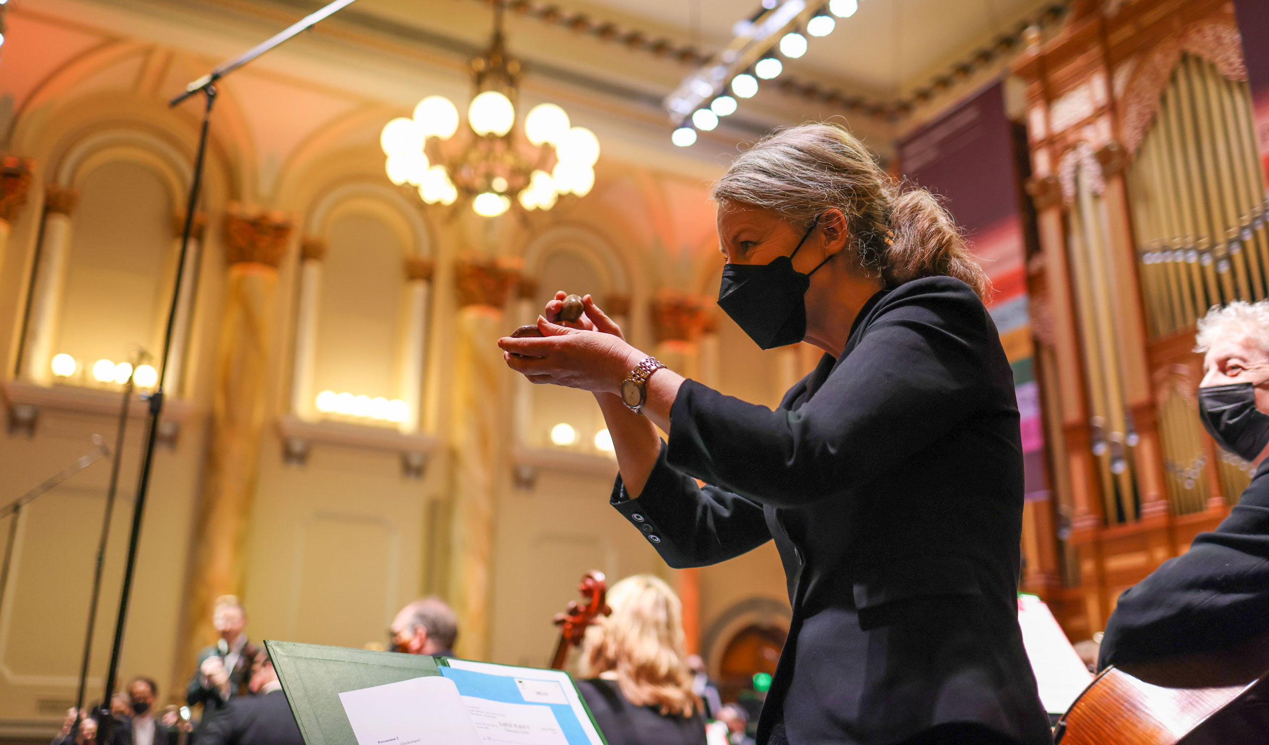 Serenity: Percussion player Amanda Grigg plays river stones, which were also given to 100 audience members to tap on queue in Cathy Milliken’s 'Ediacaran Fields'. Photo: Tony Lewis