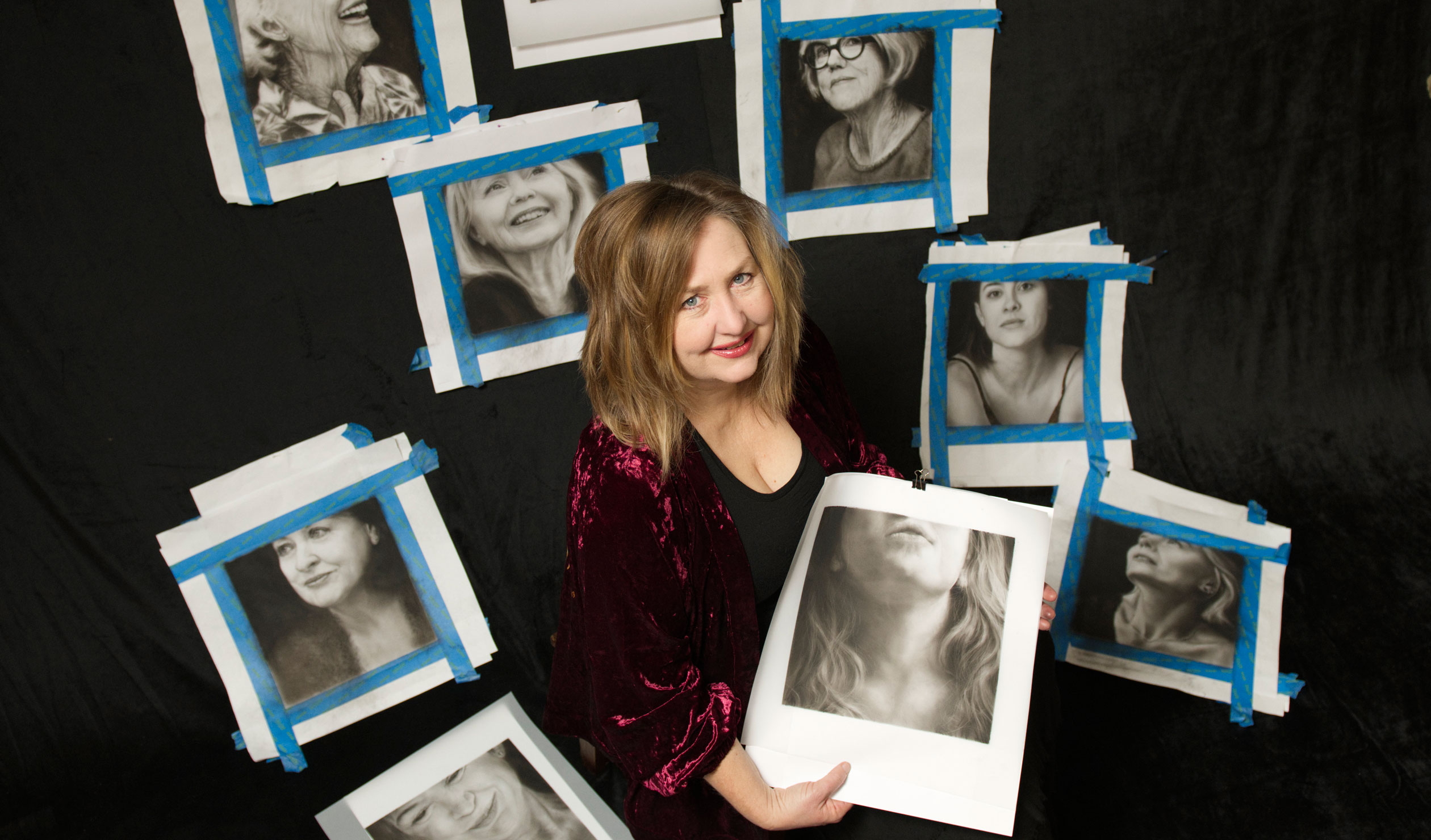 Margaret Ambridge with some of the charcoal portraits from her 'Becoming Invisible?' exhibition at praxis ARTSPACE. Photo: Mark Fitz-Gerald