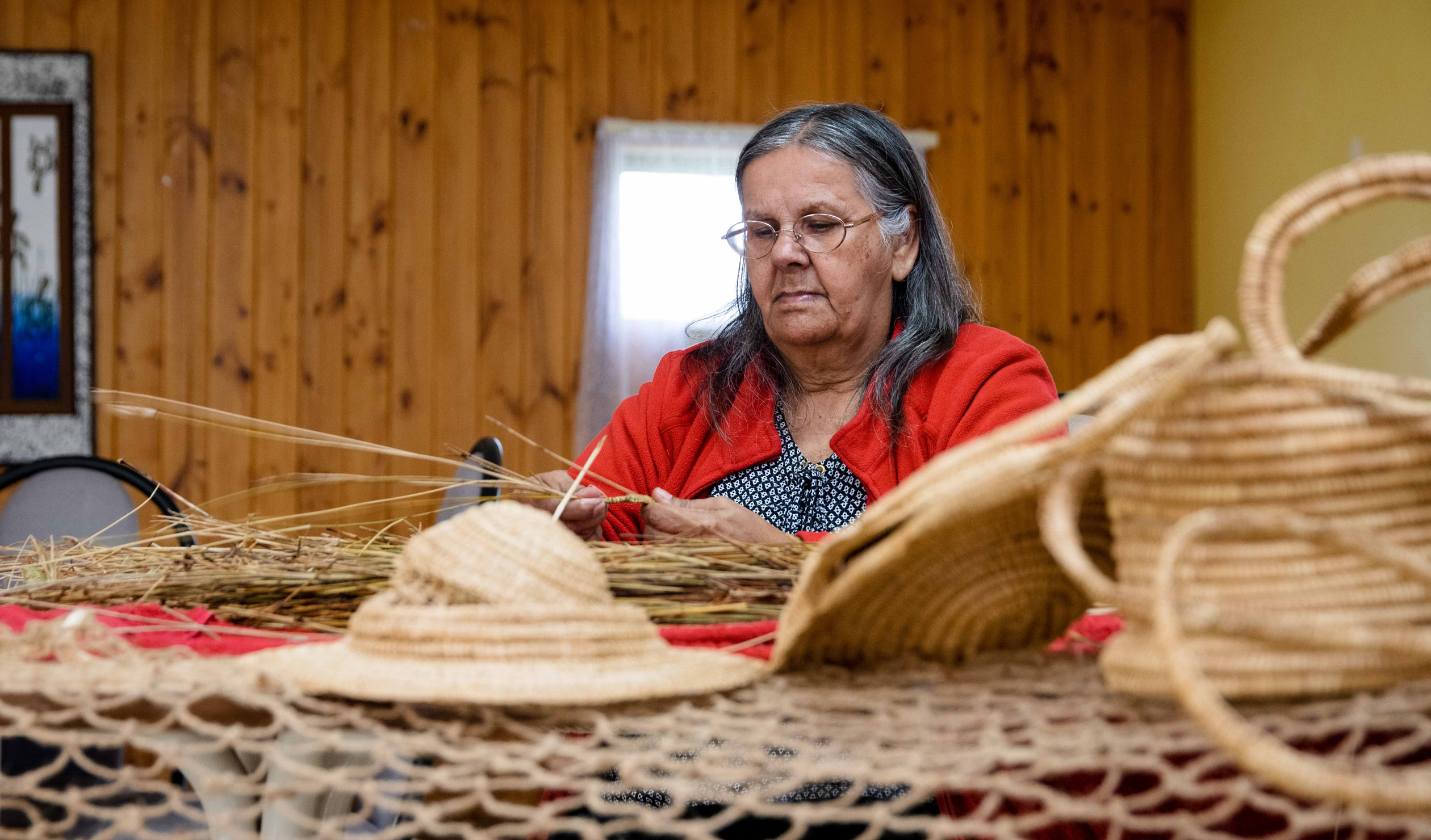 Ngarrindjeri elder and celebrated weaver Aunty Ellen Trevorrrow creating her artworks at Camp Coorong. Photo: Jack Fenby