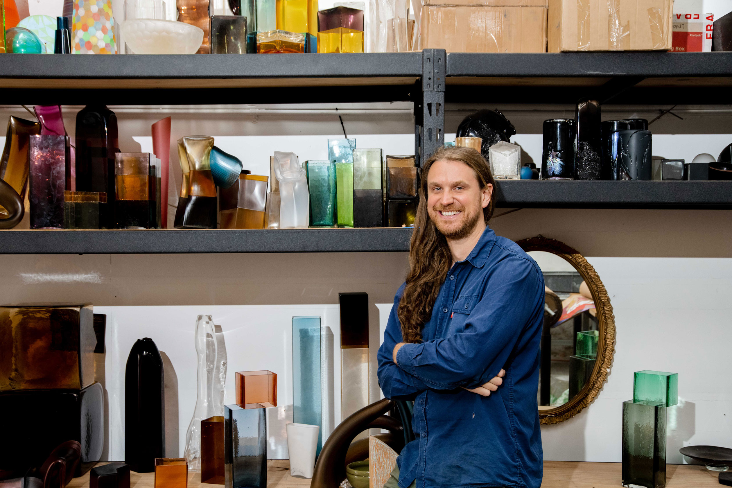 Liam Fleming with some of his work in the Queen’s Court studio he shares with two other glass artists. Photo: Jack Fenby