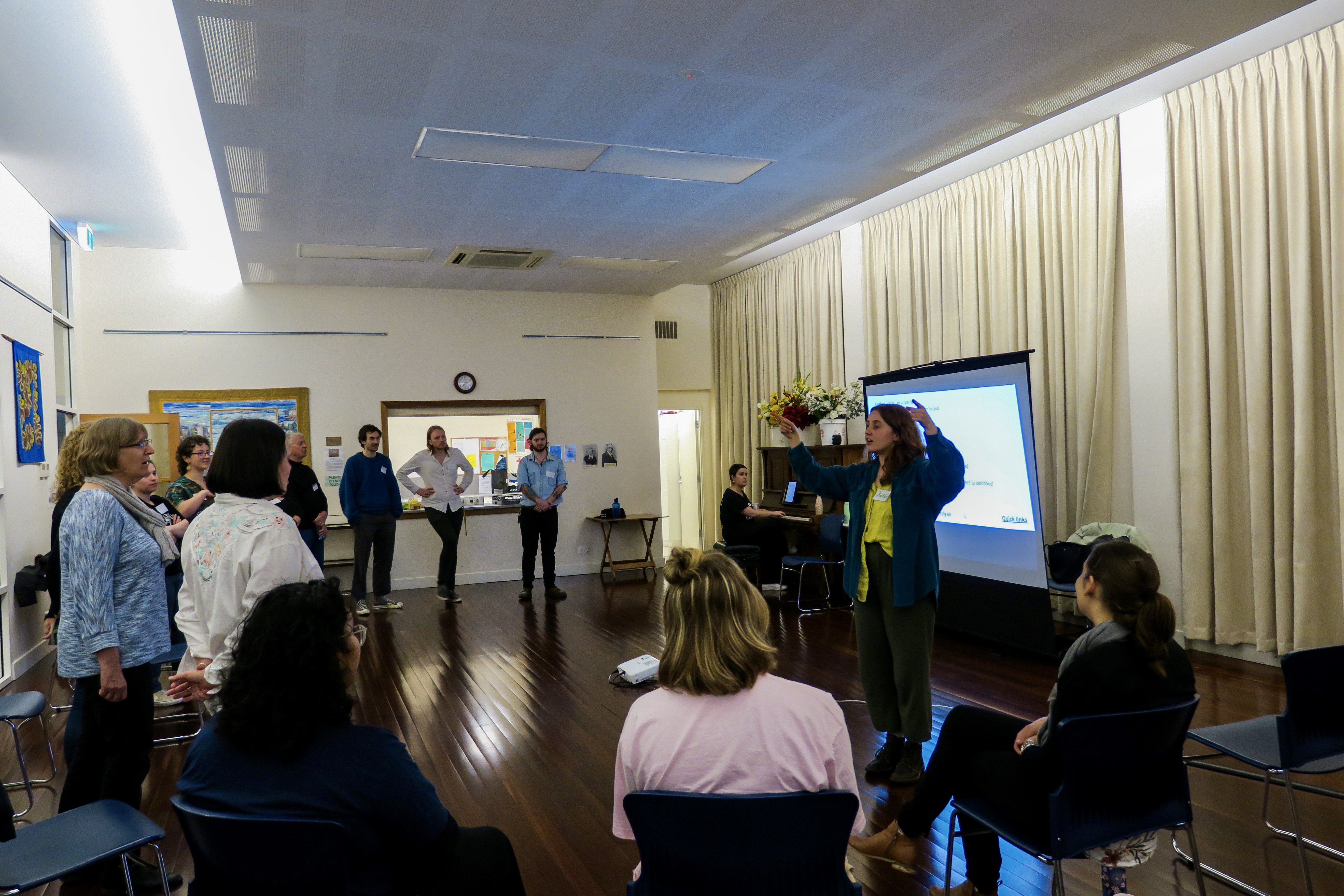 Katie Pomery conducts members of the One Voice Adelaide CBD choir during a session in Scots Church. Photo: Jason Katsaras / InReview