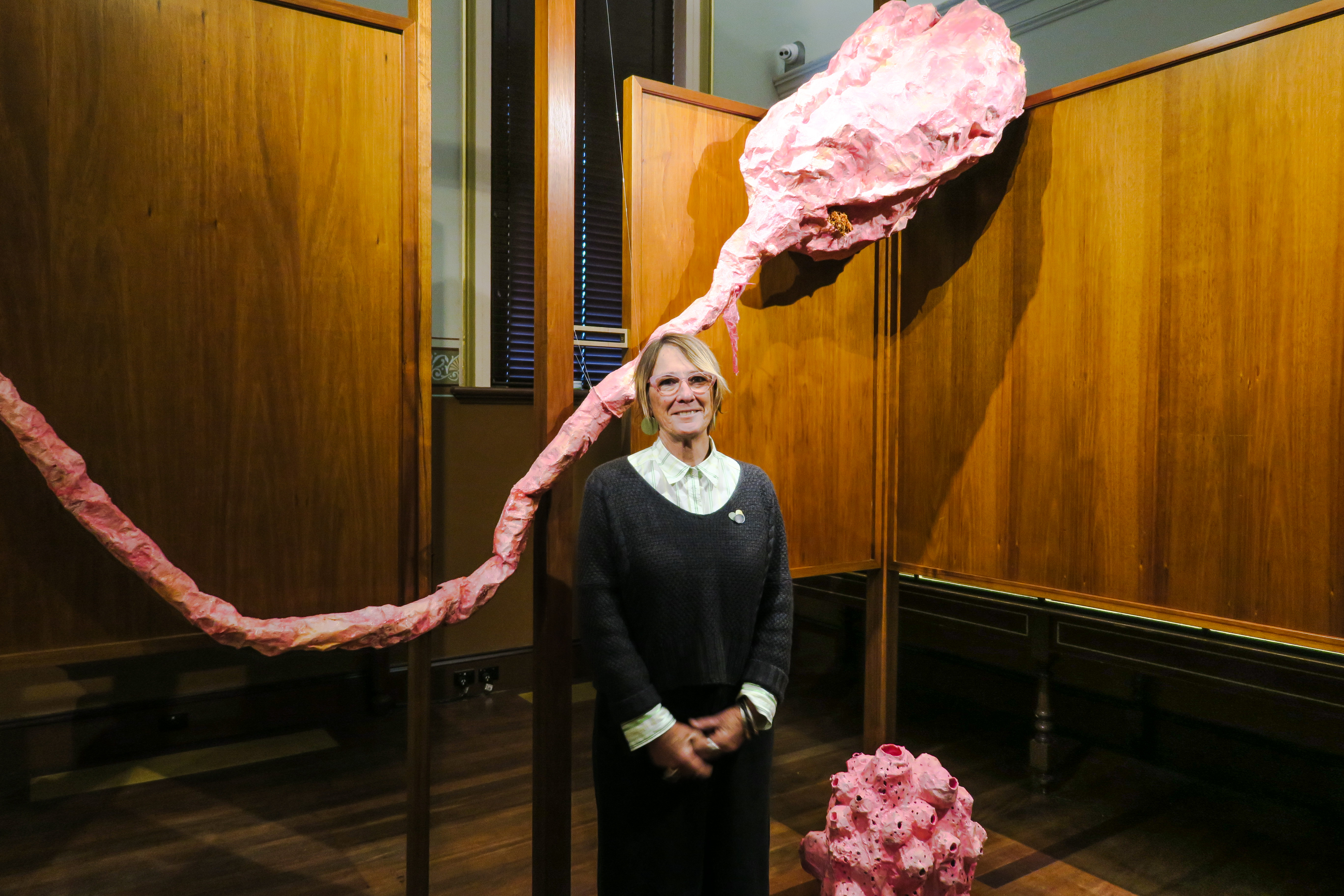 Chris De Rosa at the Santos Museum of Economic Botany with a large paper-mache sculpture and a smaller spongia inspired by other paper-mache mushrooms which inhabit the museum year round. Photo: Jason Katsaras / InReview