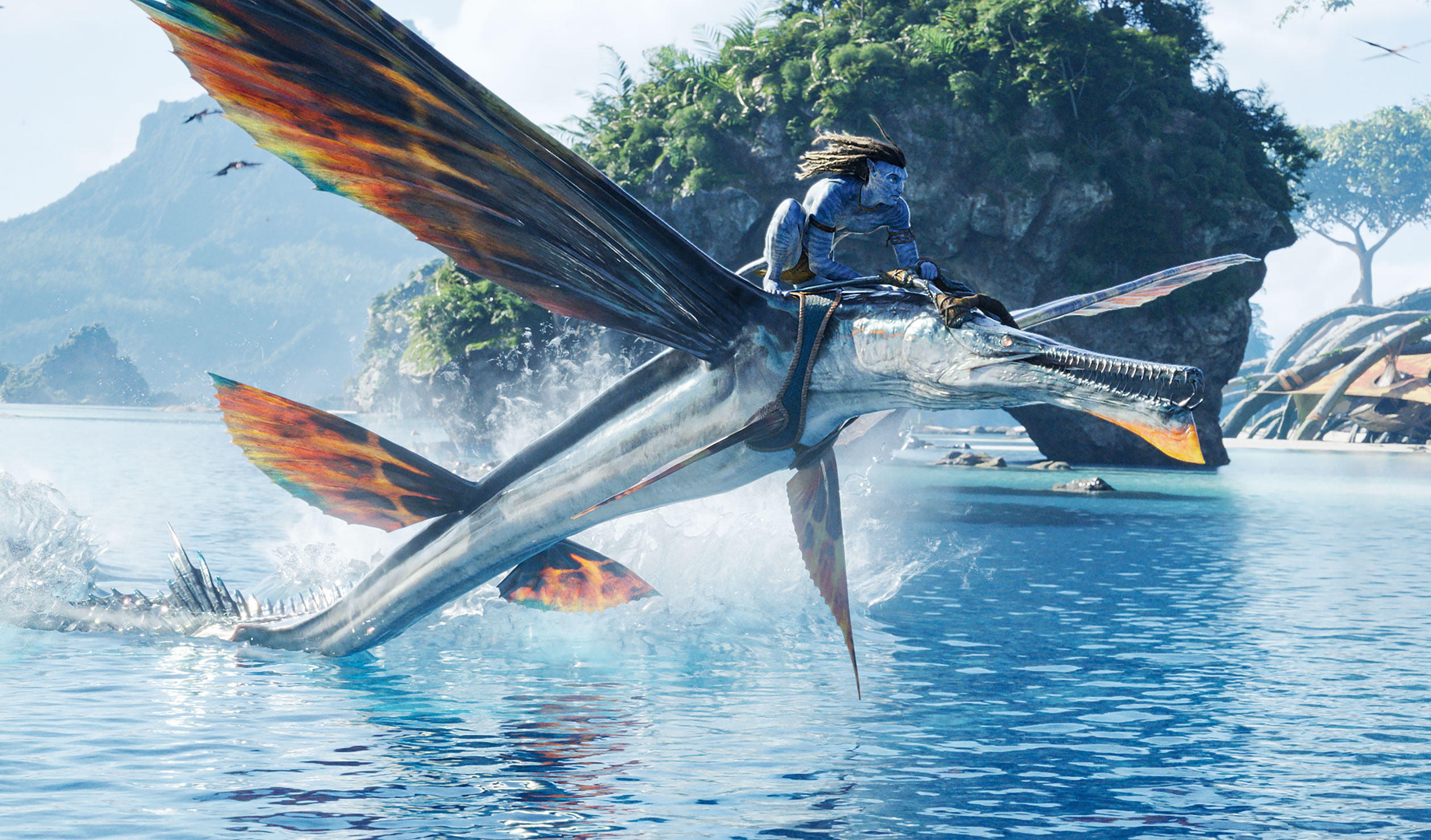 The Na’vi people soar through the sky on colour-splashed dragons. Photo: Vanessa Lastro / 20th Century Studios 