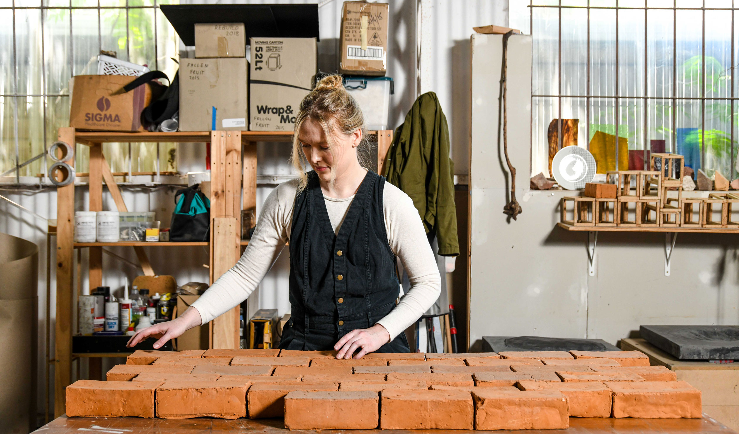 Bernadette Klavins in her Norwood studio with a set of bricks that were connected to an exhibition exploring the impact of humans as geologic agents. Photo: Jack Fenby / InReview