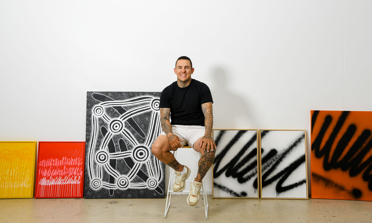 Shane Cook with some of his artworks in his East End studio. Photo: Jack Fenby / InReview