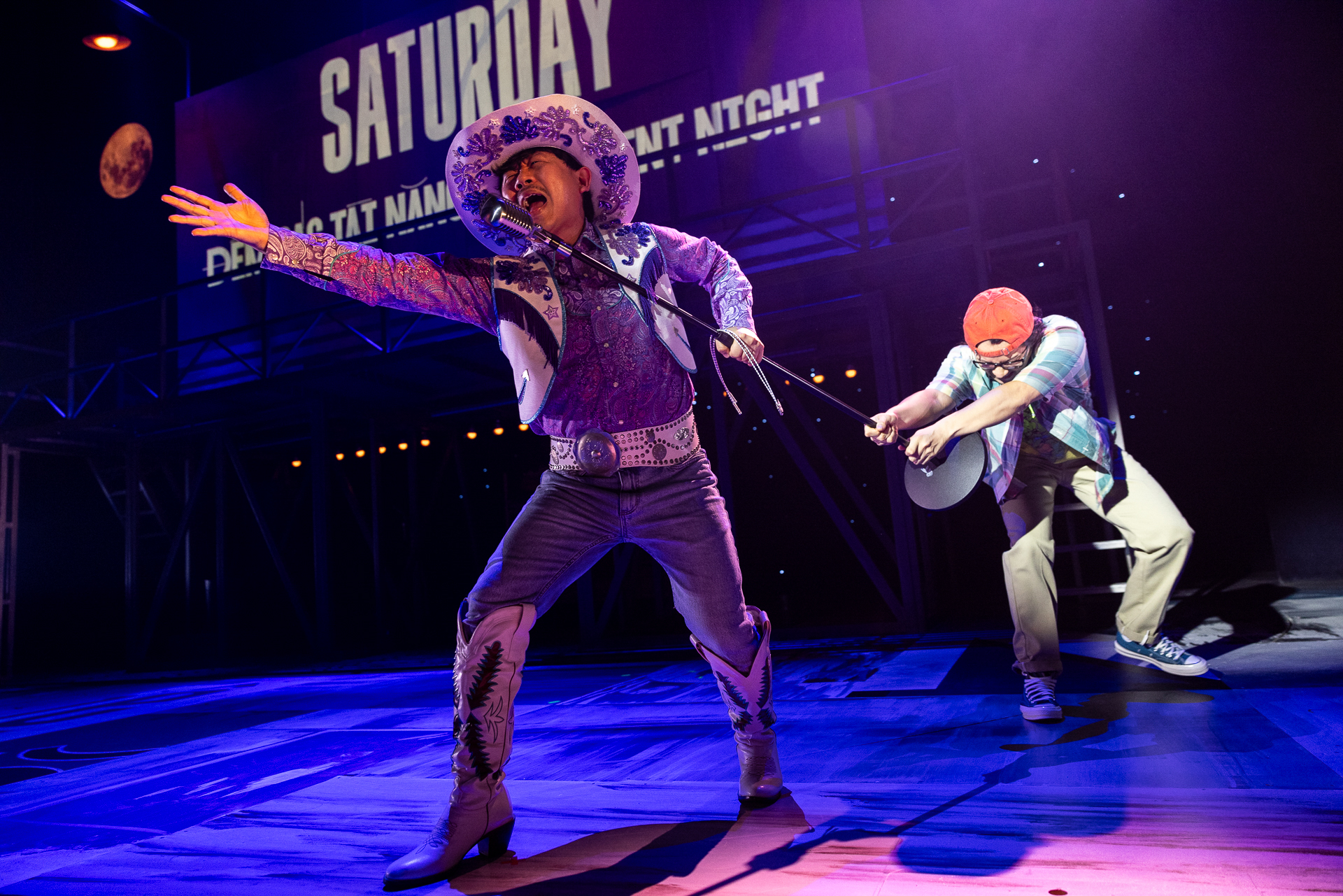 Aljin Abella has to be dragged off the stage to stop him singing in Vietgone. Photo by Brett Boardman