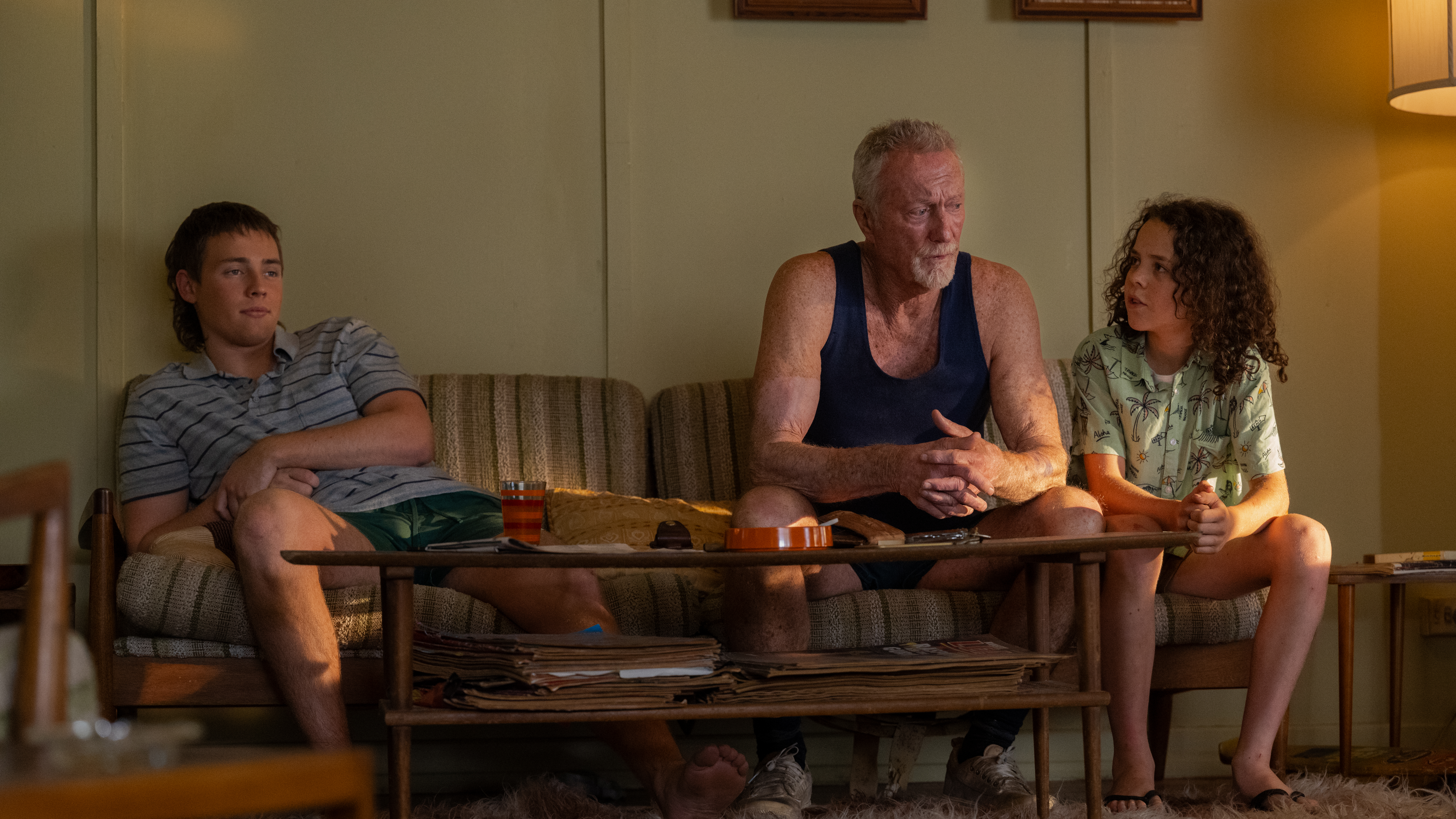 Actors Lee Halley, Bryan Brown and Felix Cameron in a scene from Netflix smash hit Boy Swallows Universe, the latest screen adaptation of a book set in Brisbane. Photo: Courtesy of Netflix © 2023