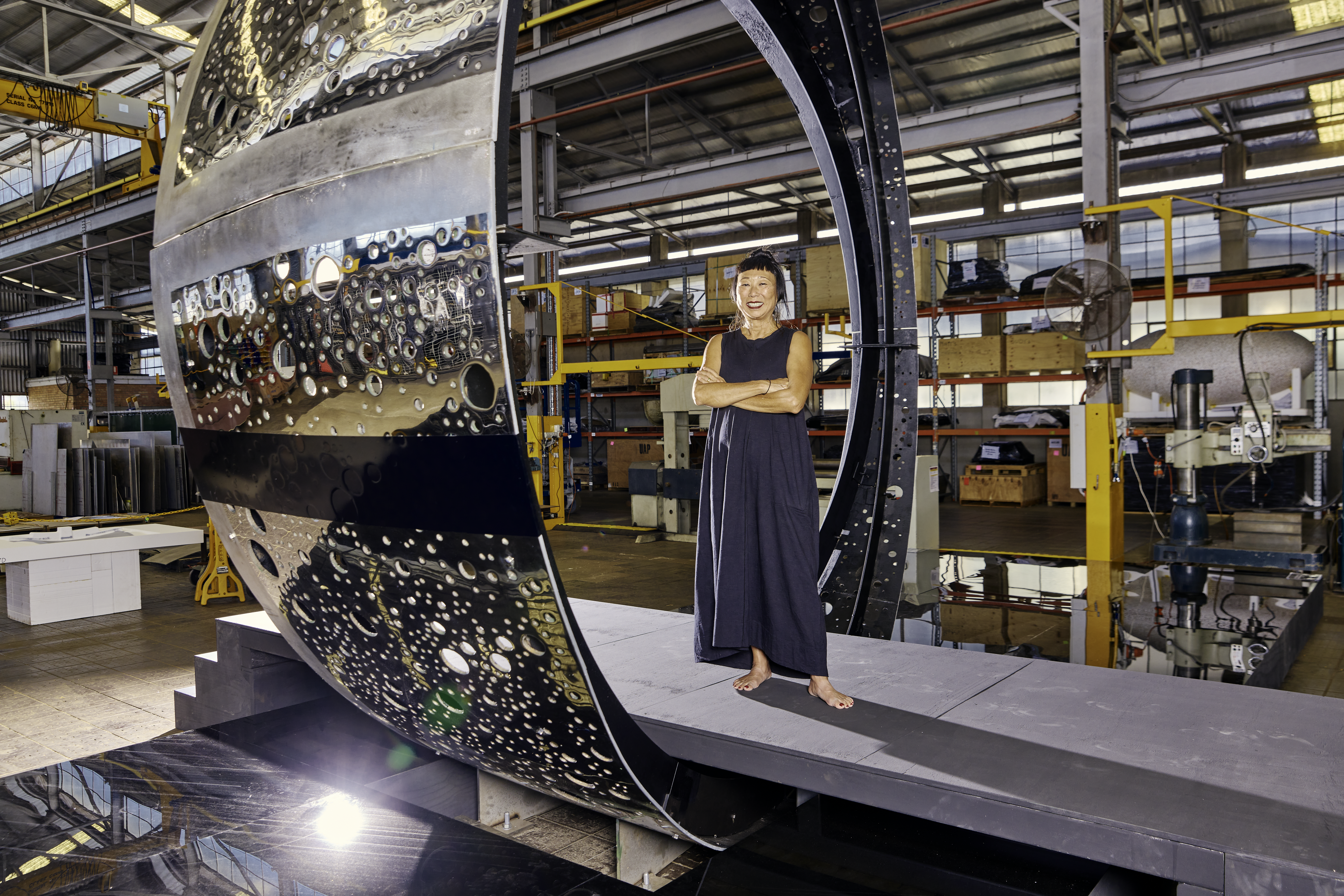 Artist Lindy Lee at UAP in Northgate, Brisbane, with her installation artwork Ouroboros in its early stages. Photo:  Josef Ruckli 