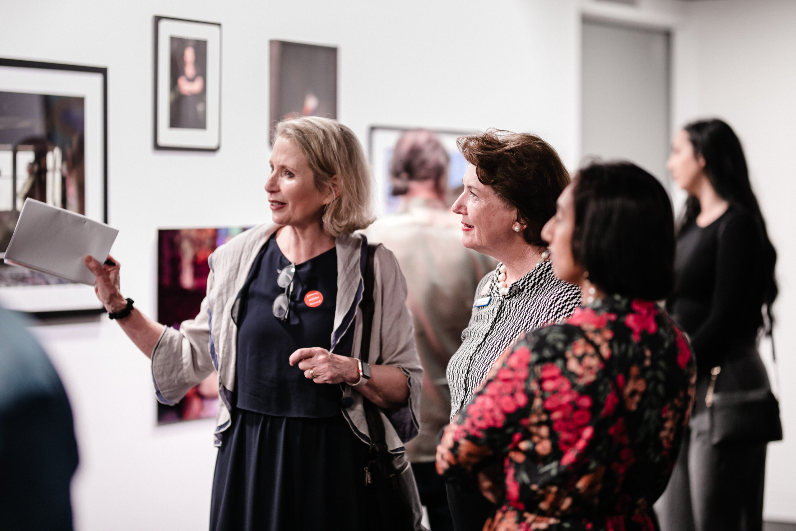 Anna Reynolds shows off last year's Brisbane Portrait Prize to BCC Councillor Vicki Howard.